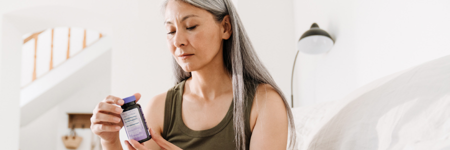Image of a person looking at a supplement bottle