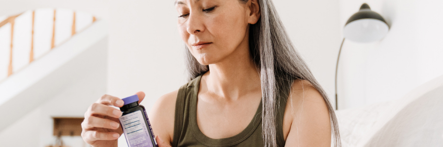 Image of a person looking at a supplement bottle