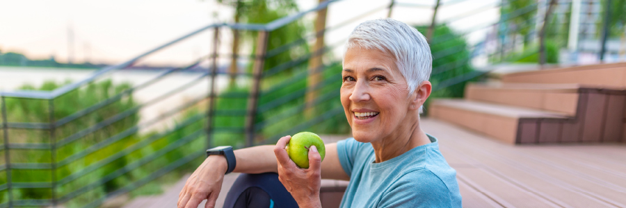 Image of a person eating an apple outdoors