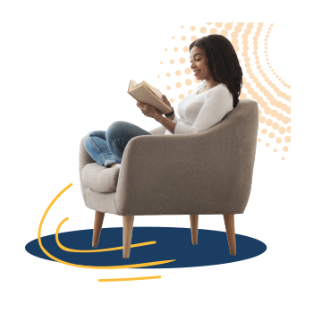 A person in an armchair reading