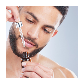 A person using a dropper into a bottle
