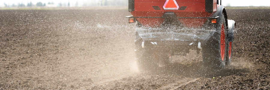 Tractor spreading fertilizer