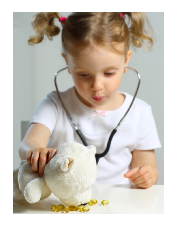 Child wearing a stethoscope and playing with a stuffed animal