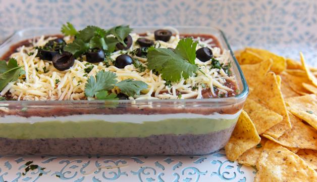 Image https://www.naturalgrocers.com/sites/default/files/styles/recipe_slider_full/public/media_images/19332_Mexican_Layer_Dip_Web_Recipe_Feature_1024x587.jpg?itok=BPdaYzXA